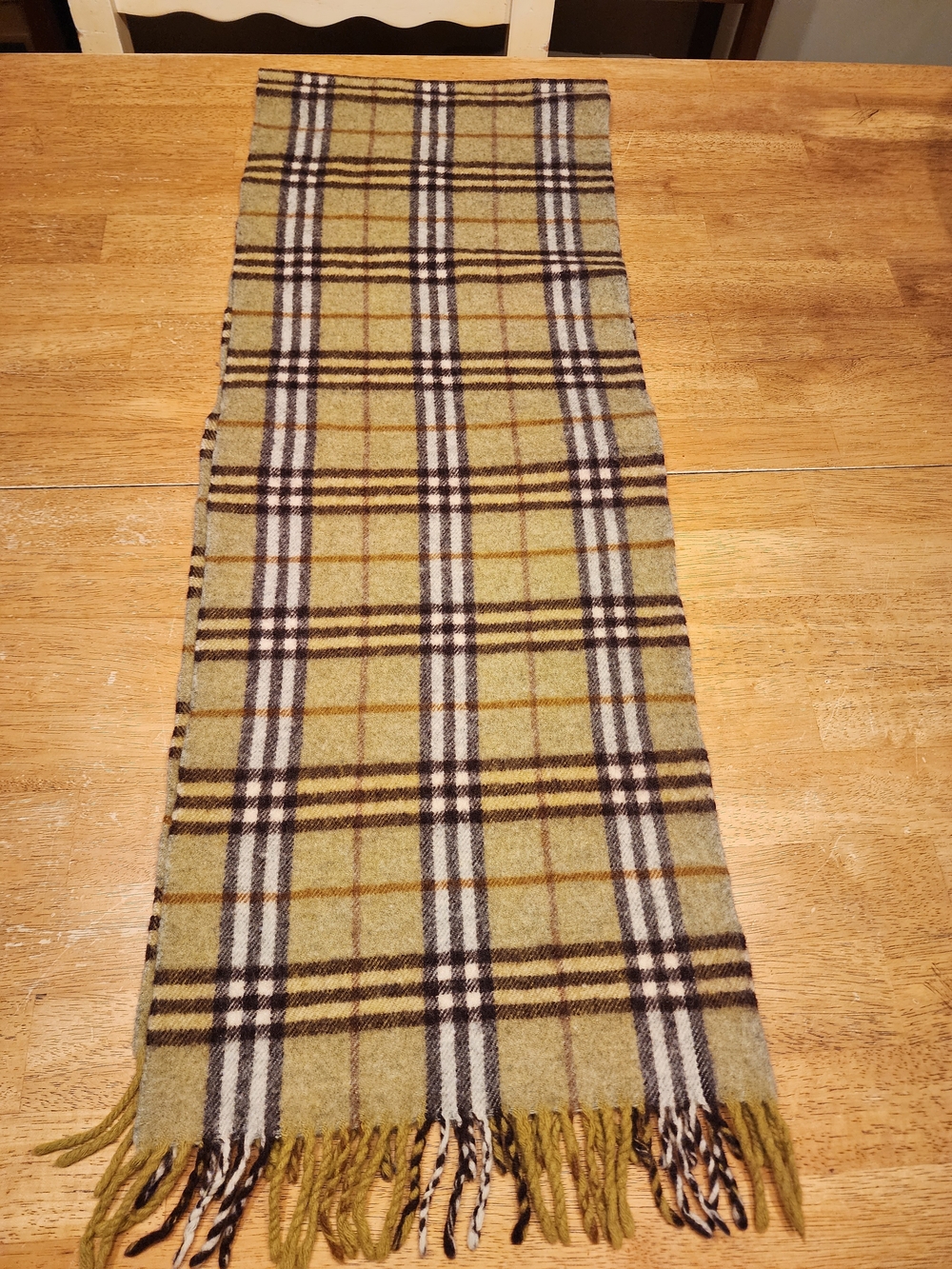 classic Burberry Green Nova Check Scarf distinguished by its olive tartan plaid